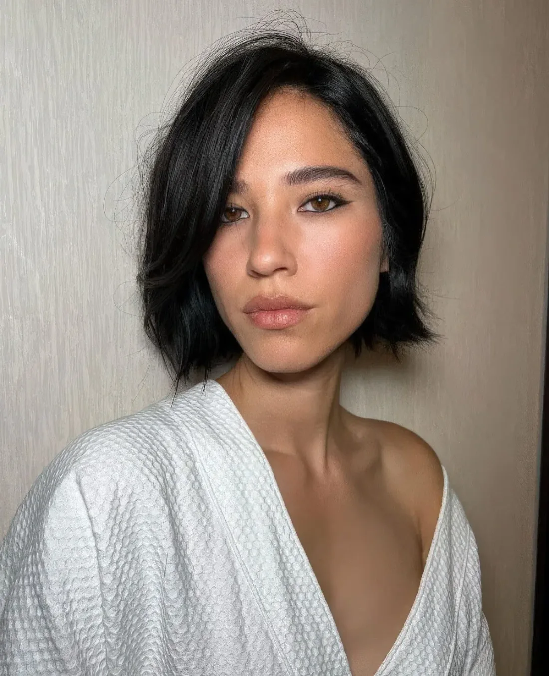 Photo showing black messy bob, with the hairstyle clearly visible.