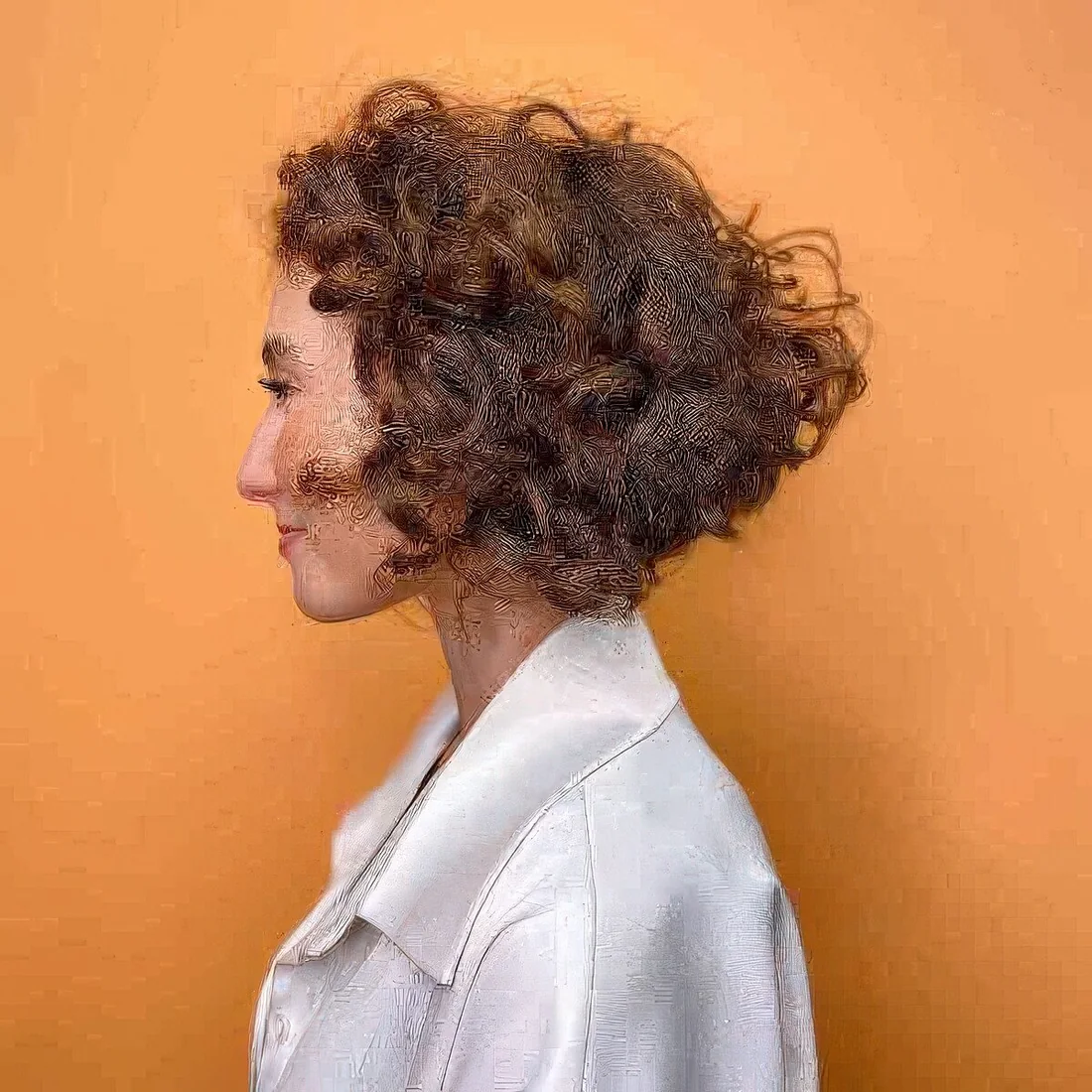 Photo showing chin-length curly inverted bob, with the hairstyle clearly visible.