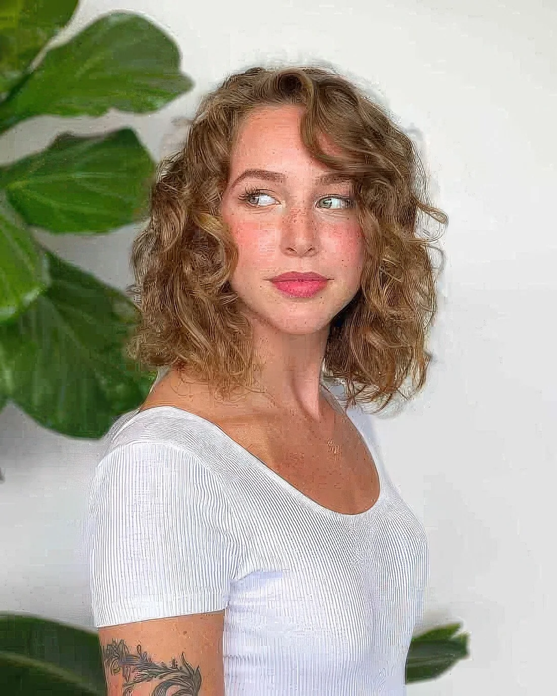 Curly long bob done in soft honey blonde.