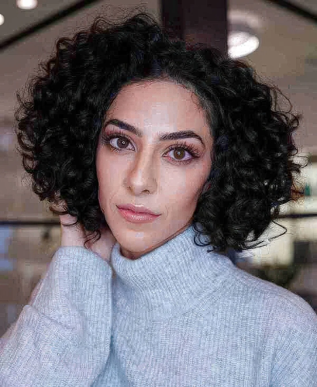 Curly French bob with square layers to amplify the coils and create width for a balance.