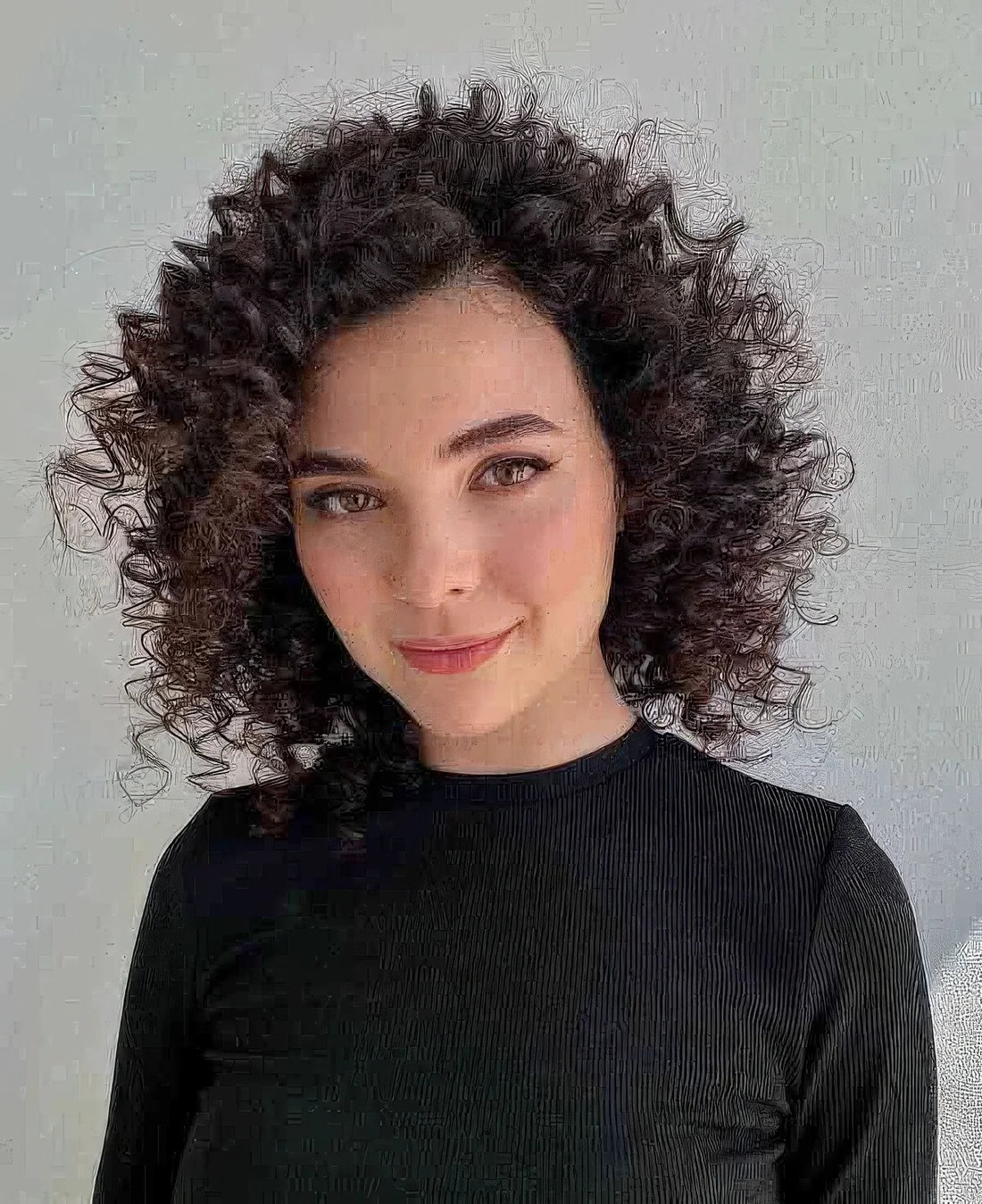 Frizzy curly long bob shows off the texture and the beauty of the curls and.
