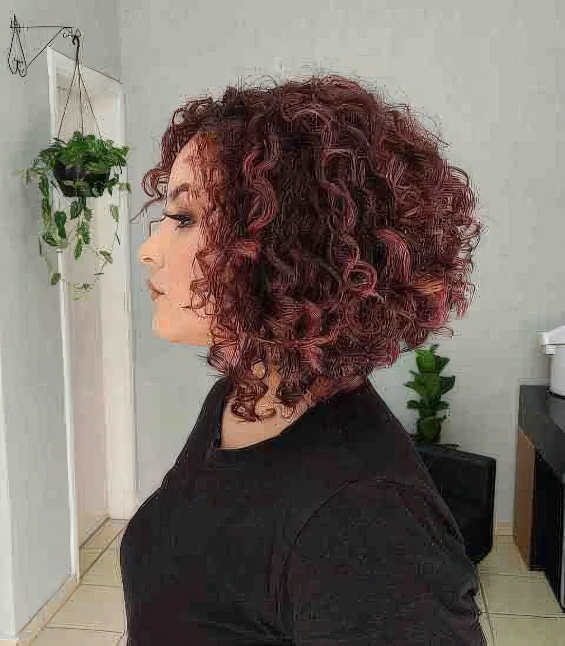 Auburn curly angled bob with graduated layers to give height and remove bulk.