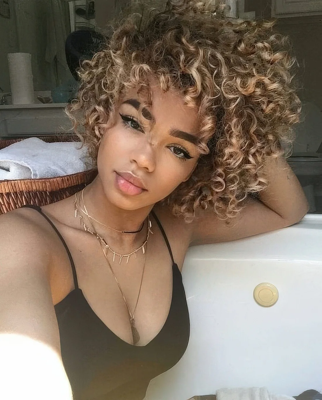 Natural curls with caramel blonde balayage.