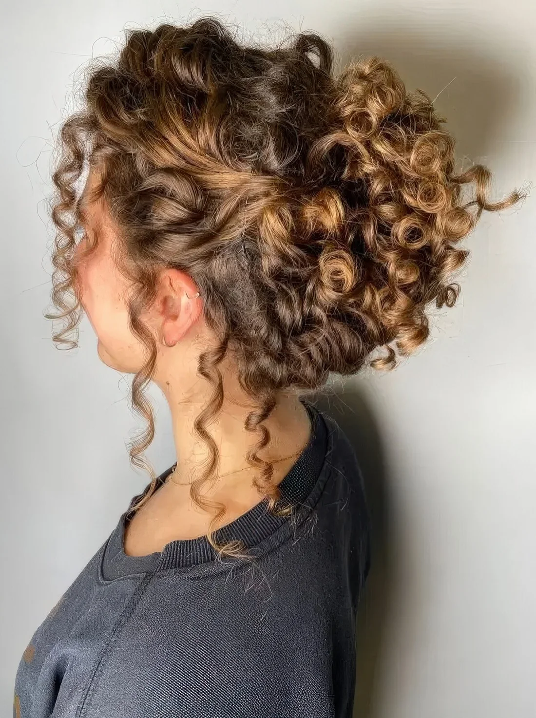 Complicated curly hairstyle with a curly top and some curls down to make it look more effortless.