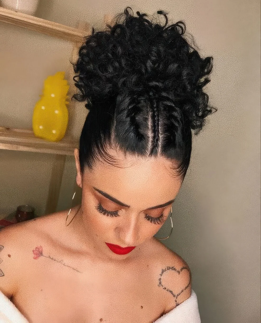 Eye catchy curly updo with curls on top and several braids added.