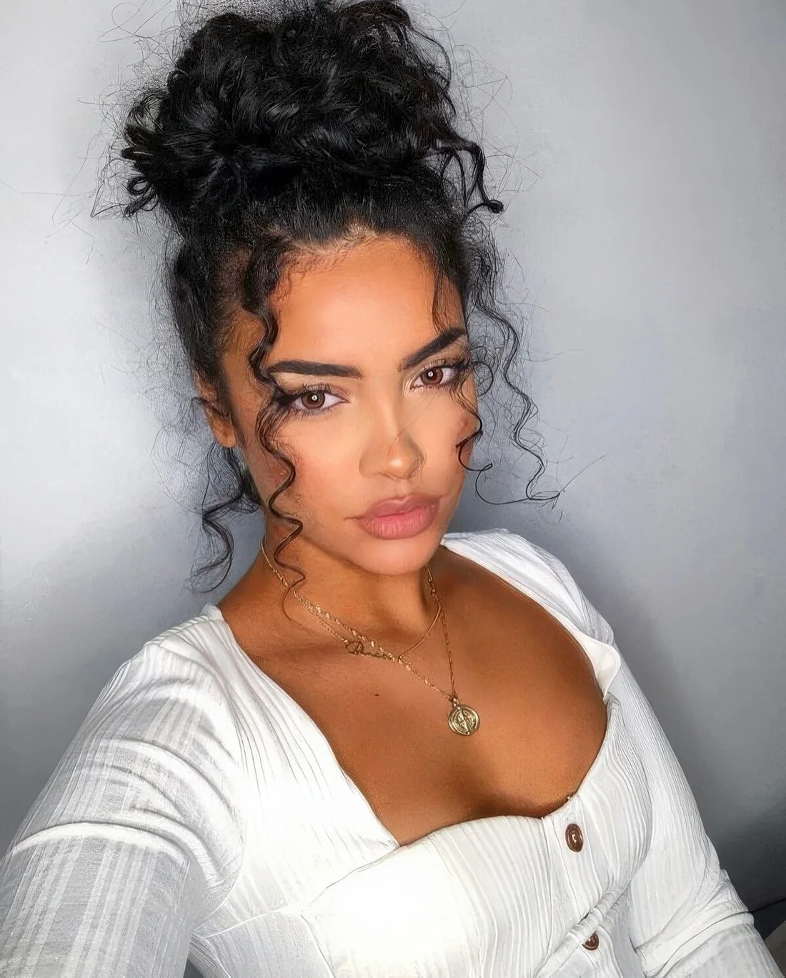 Messy and volumetric wavy top knot and curls down are a super chic and lovely hairstyle.