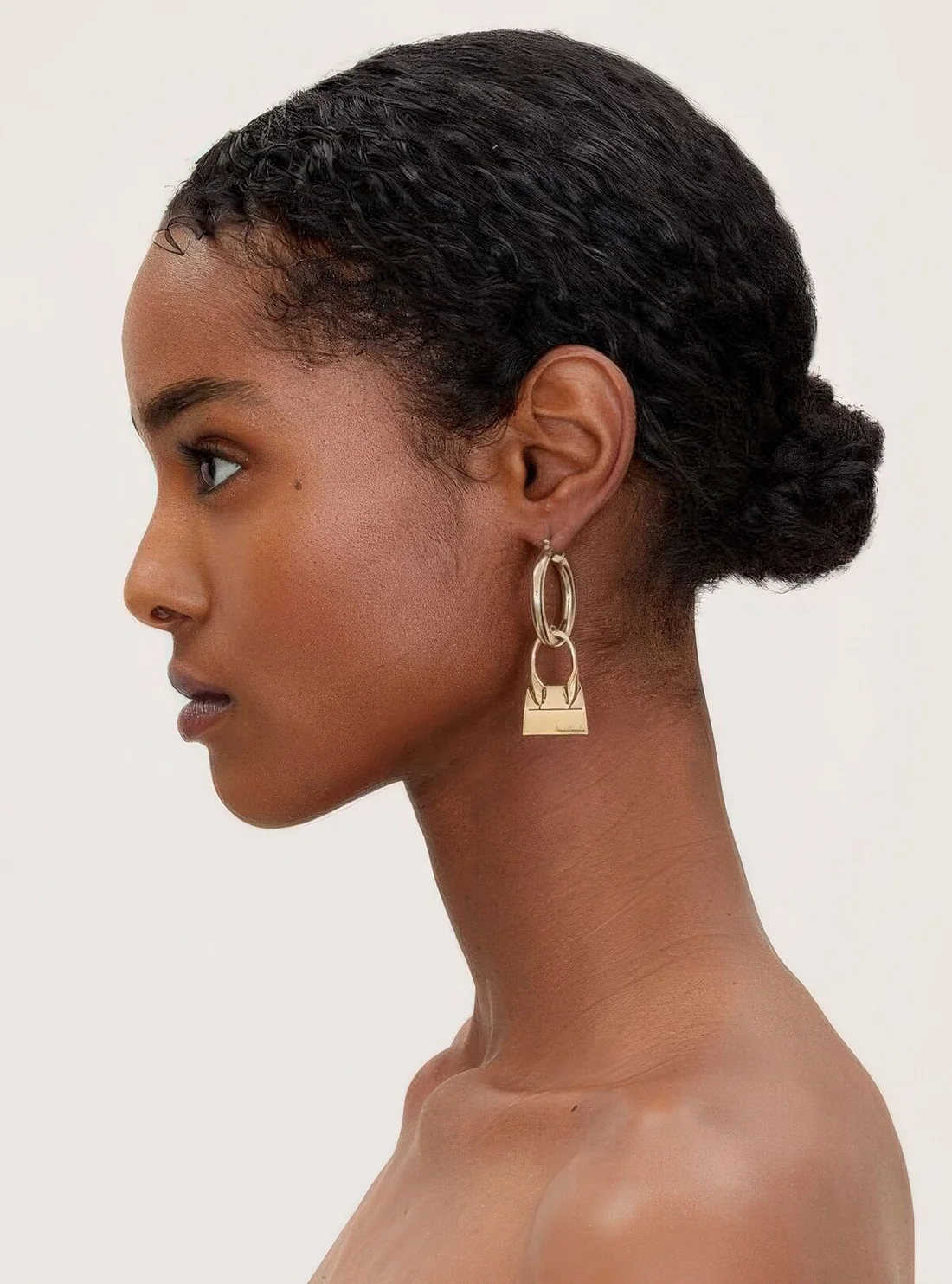 If you want a sleeker and smaller bun, straighten your curls before making the hairstyle.