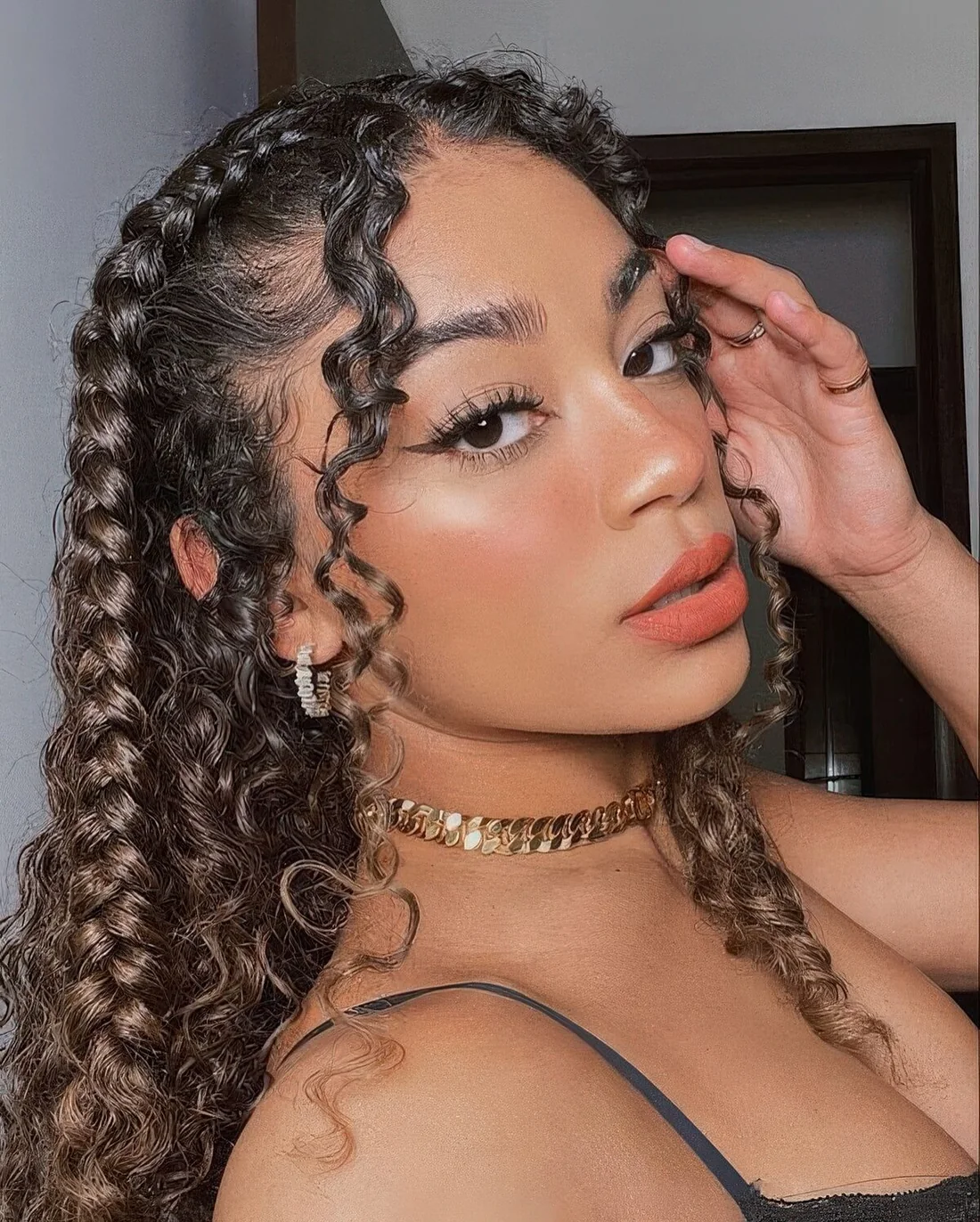 Curls down, face-framing bangs and French braids to accent the beauty of the hair.