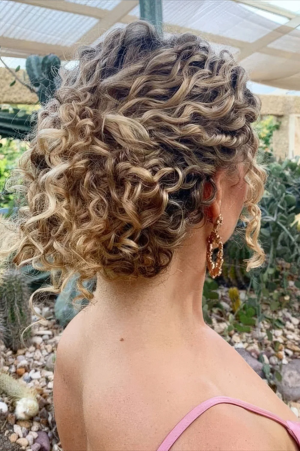 Photo showing curly wedding updo, with the hairstyle clearly visible.