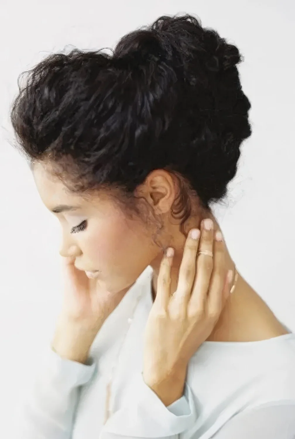 Chignon hairstyle with straightened curls.