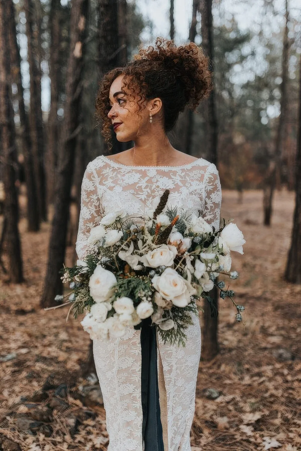 Curly updo with curls framing the face.