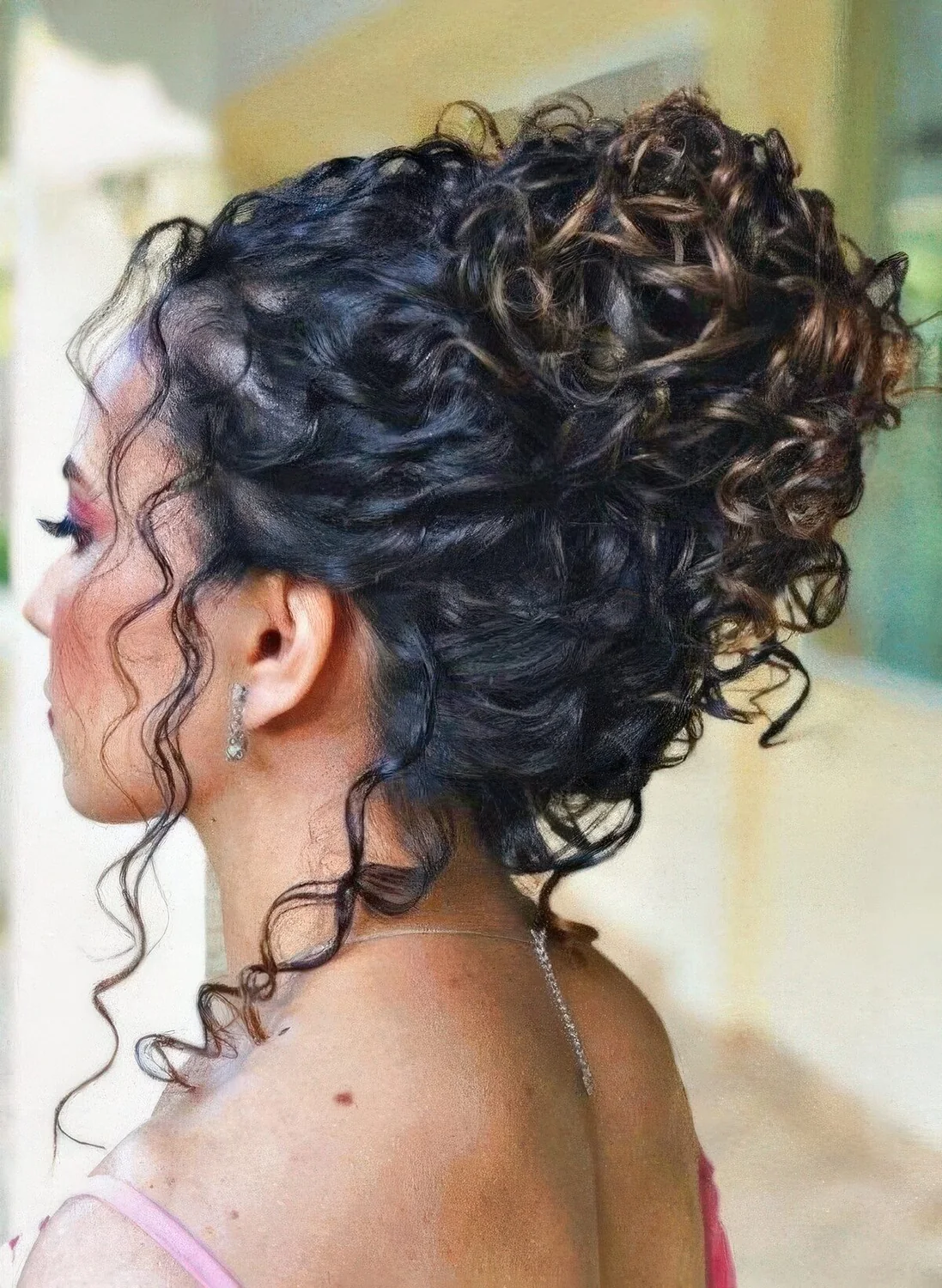 Photo showing curly updo with some curls down, with the hairstyle clearly visible.