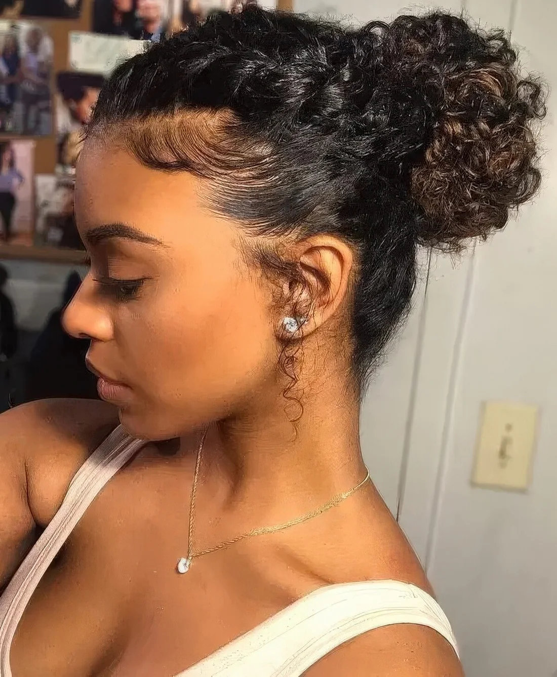 Photo showing high chignon with a side braid, with the hairstyle clearly visible.