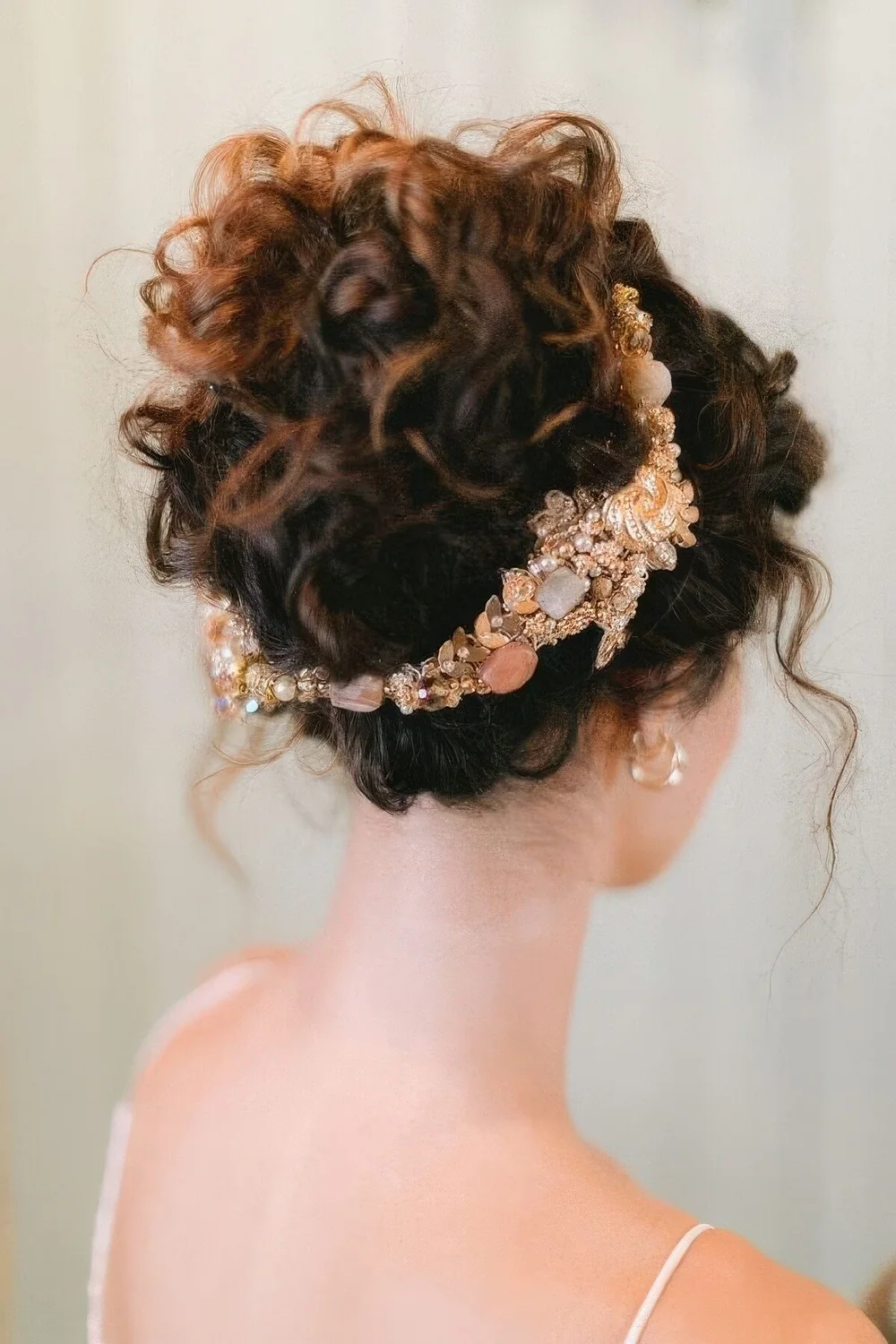 Wedding half updo with curls up and some locks down plus a gorgeous gold headband that holds the hair.
