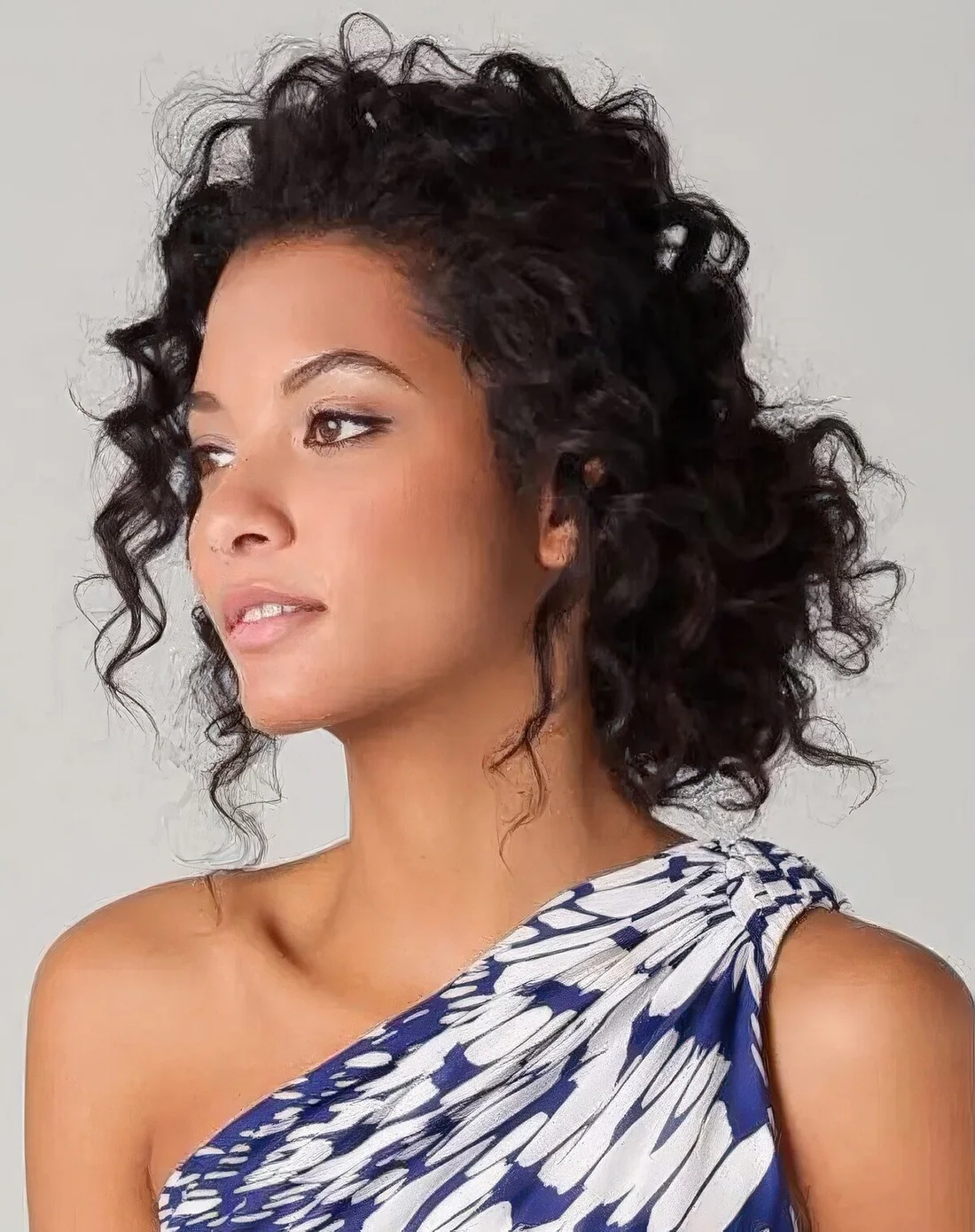 Simple low bun with curls turns into a spectacular and fantastic hairstyle, and you may DIY it easily.