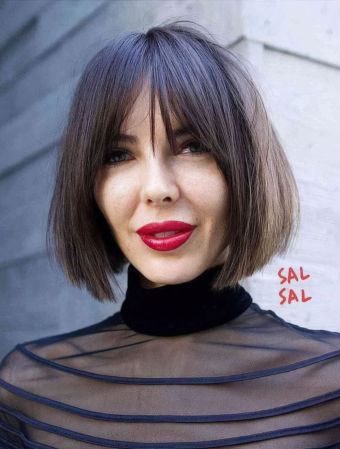 Dark brown chin-length bob with wispy bangs and plenty of texture and volume.