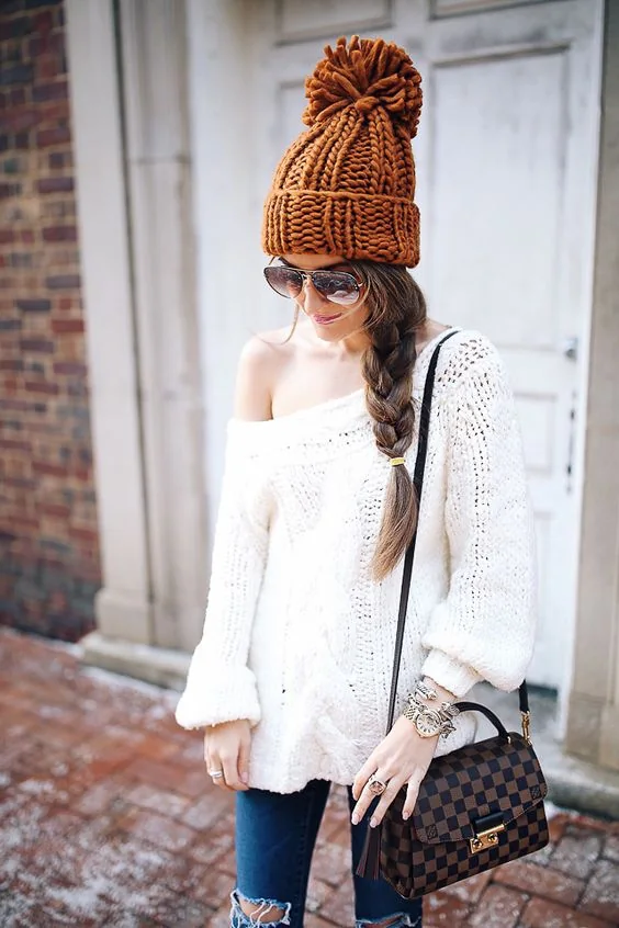 Large messy braid and a chunky knit beanie.