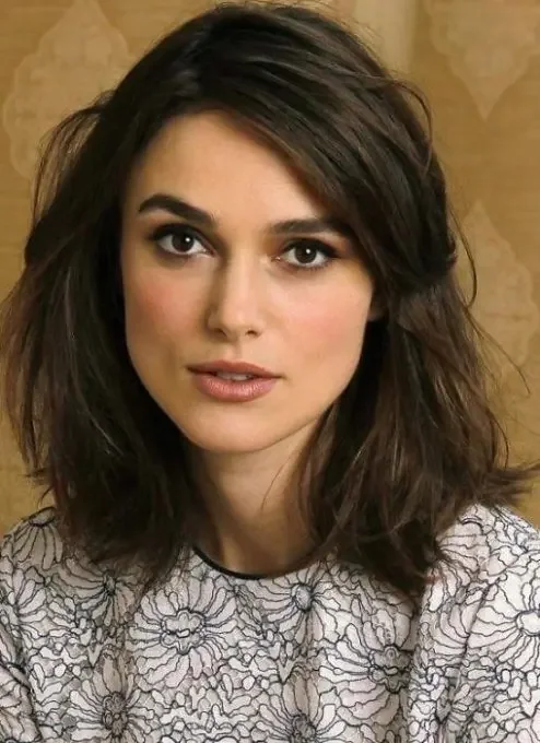 Dark brown medium-length lob and side swept bangs.