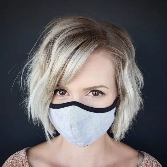 Shot and shaggy blonde bob with side bangs.