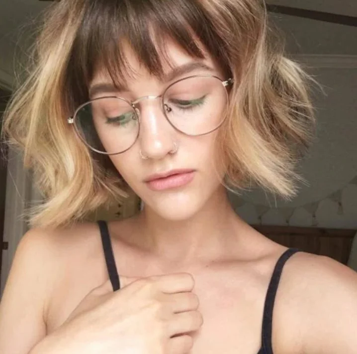 Short blonde bob with dark lowlights and see through wispy bangs.