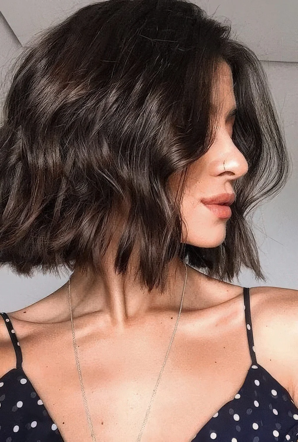 Shiny chocolate brown long bob with a bit of waves.
