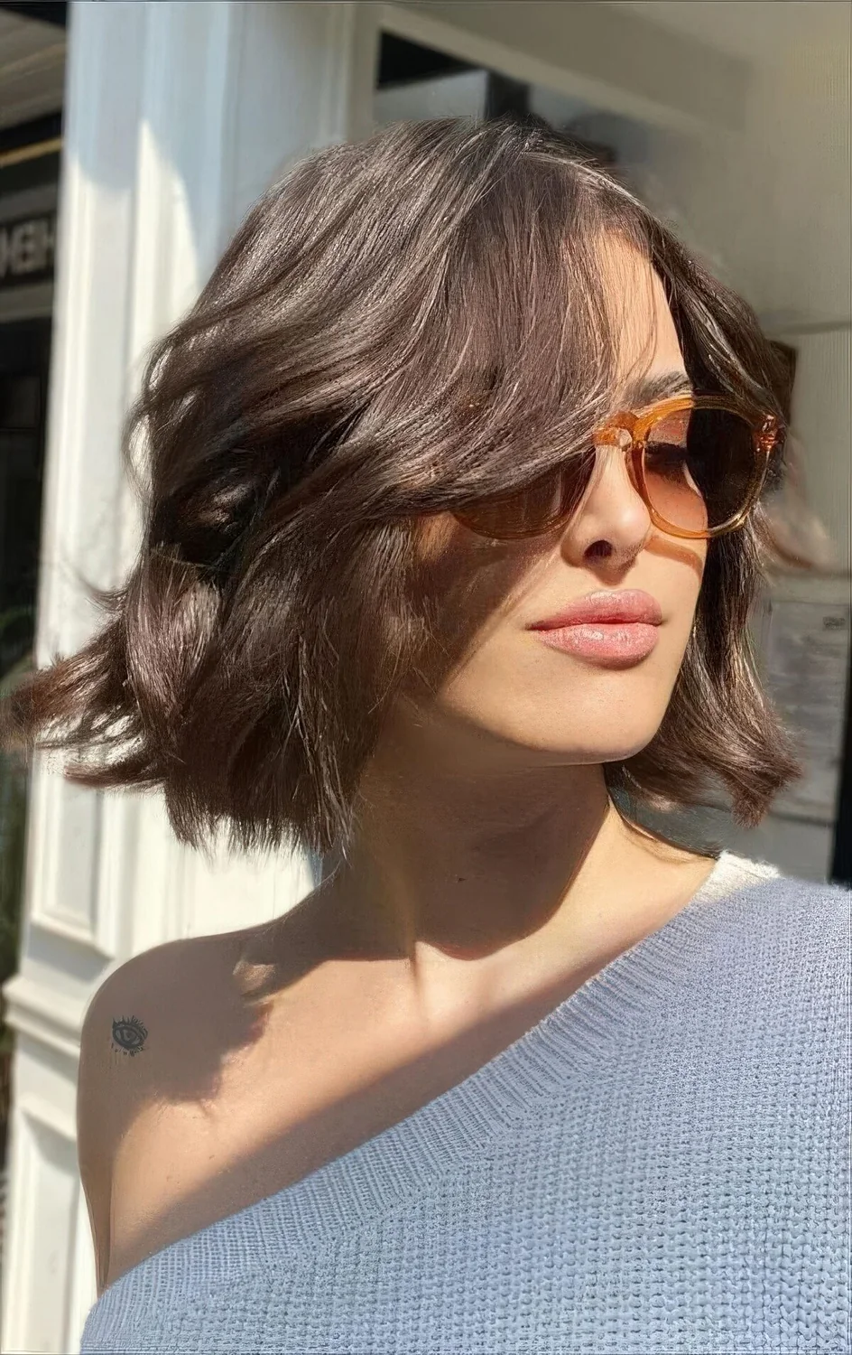 Photo showing dark brown wavy and messy bob, with the hairstyle clearly visible.