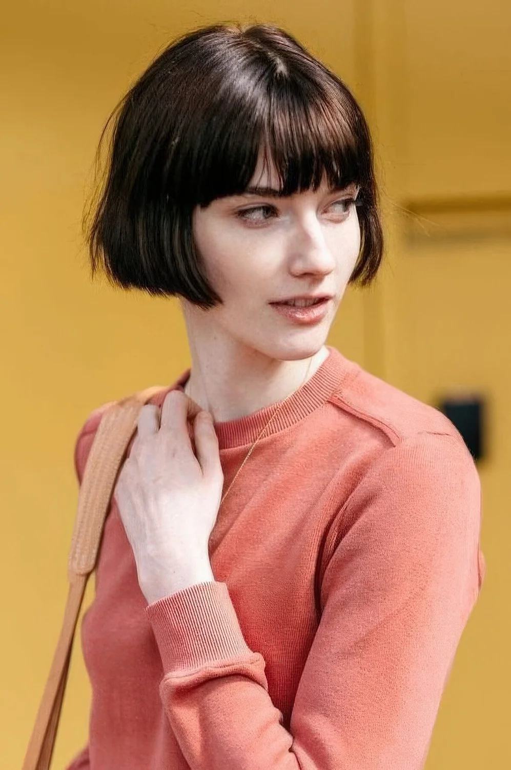 Brown ear-length bob with classic bangs and a bit of texture.