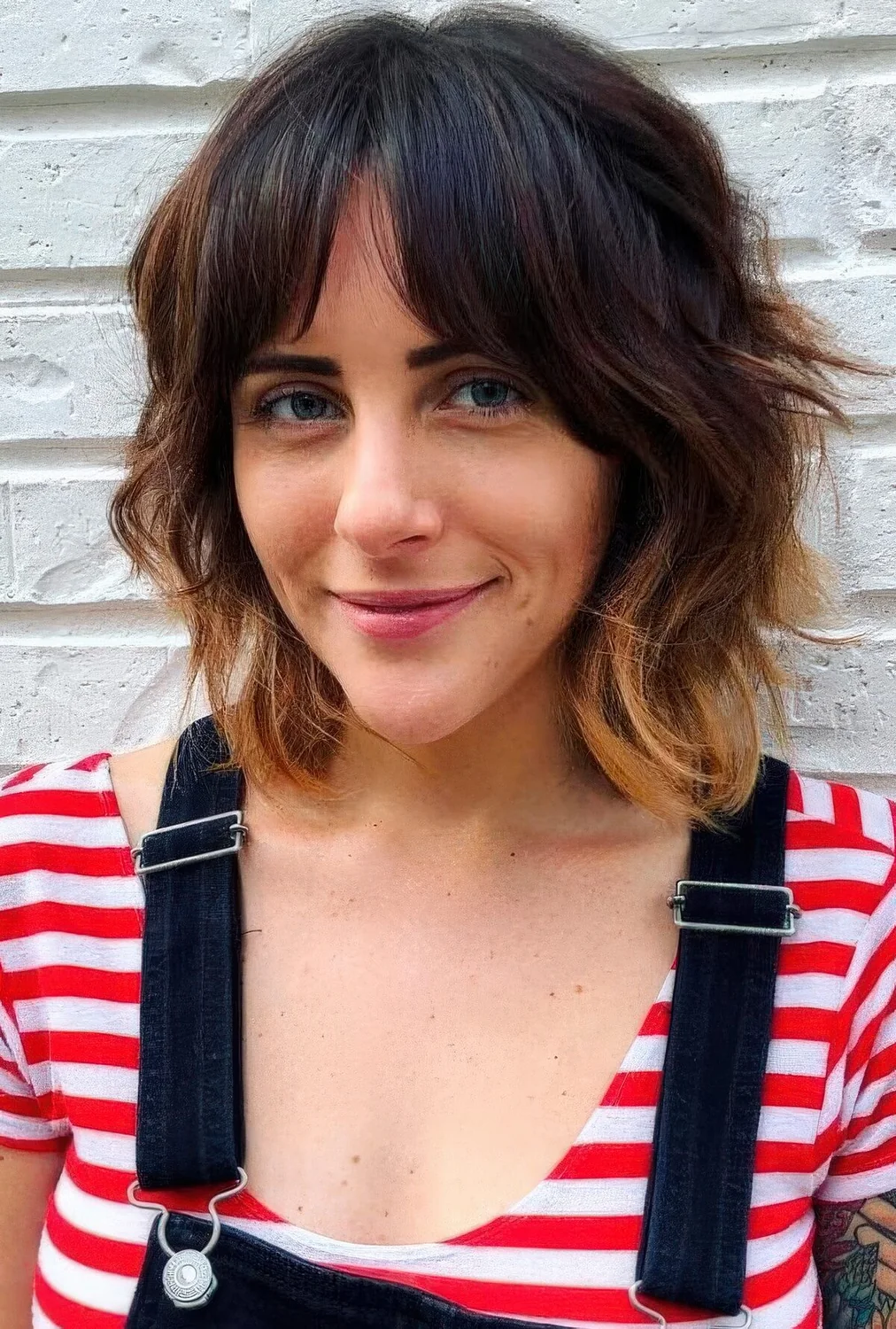 Photo showing long bob with bottleneck bangs, with the hairstyle clearly visible.