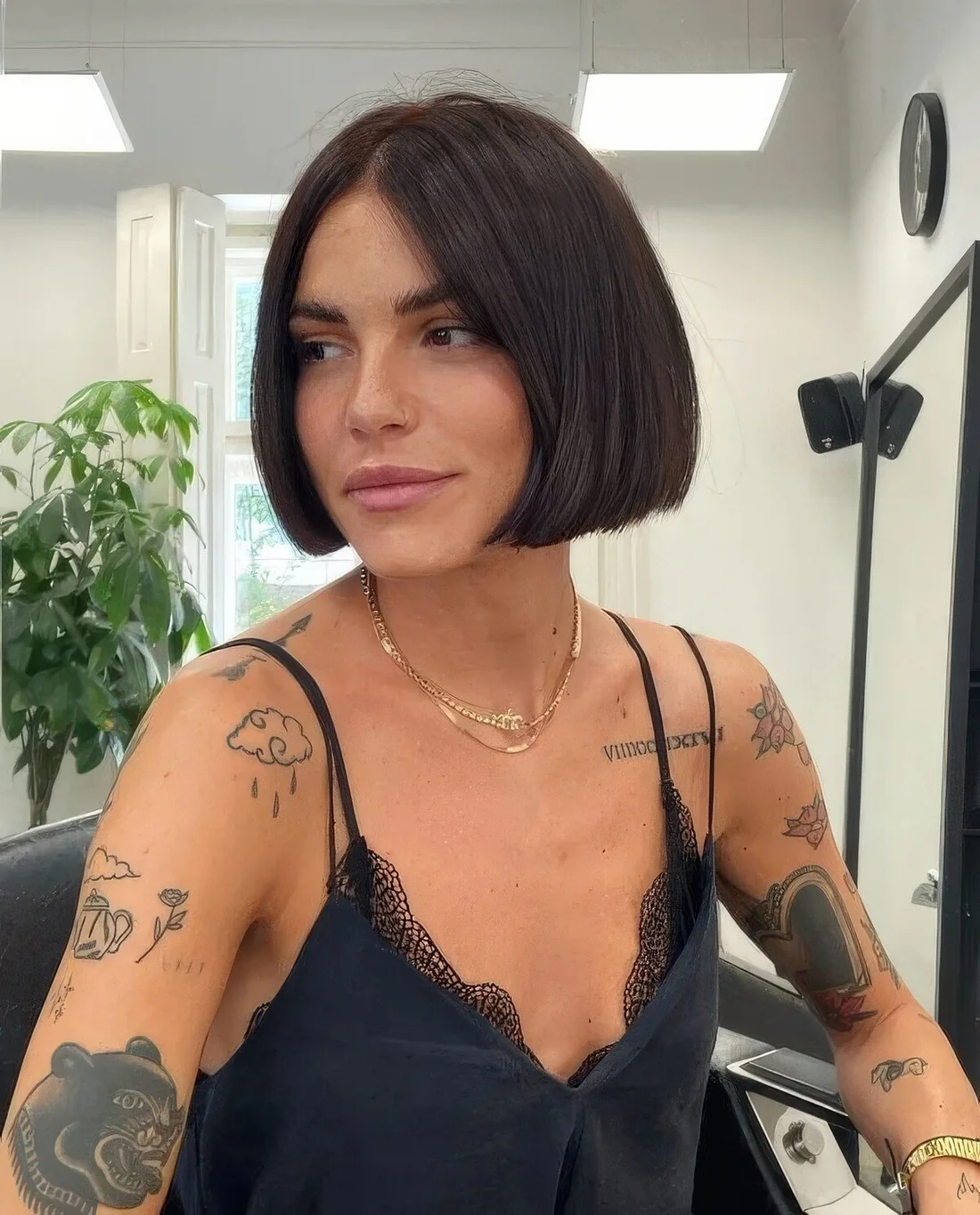 Photo showing dark brown jaw-length blunt bob, with the hairstyle clearly visible.