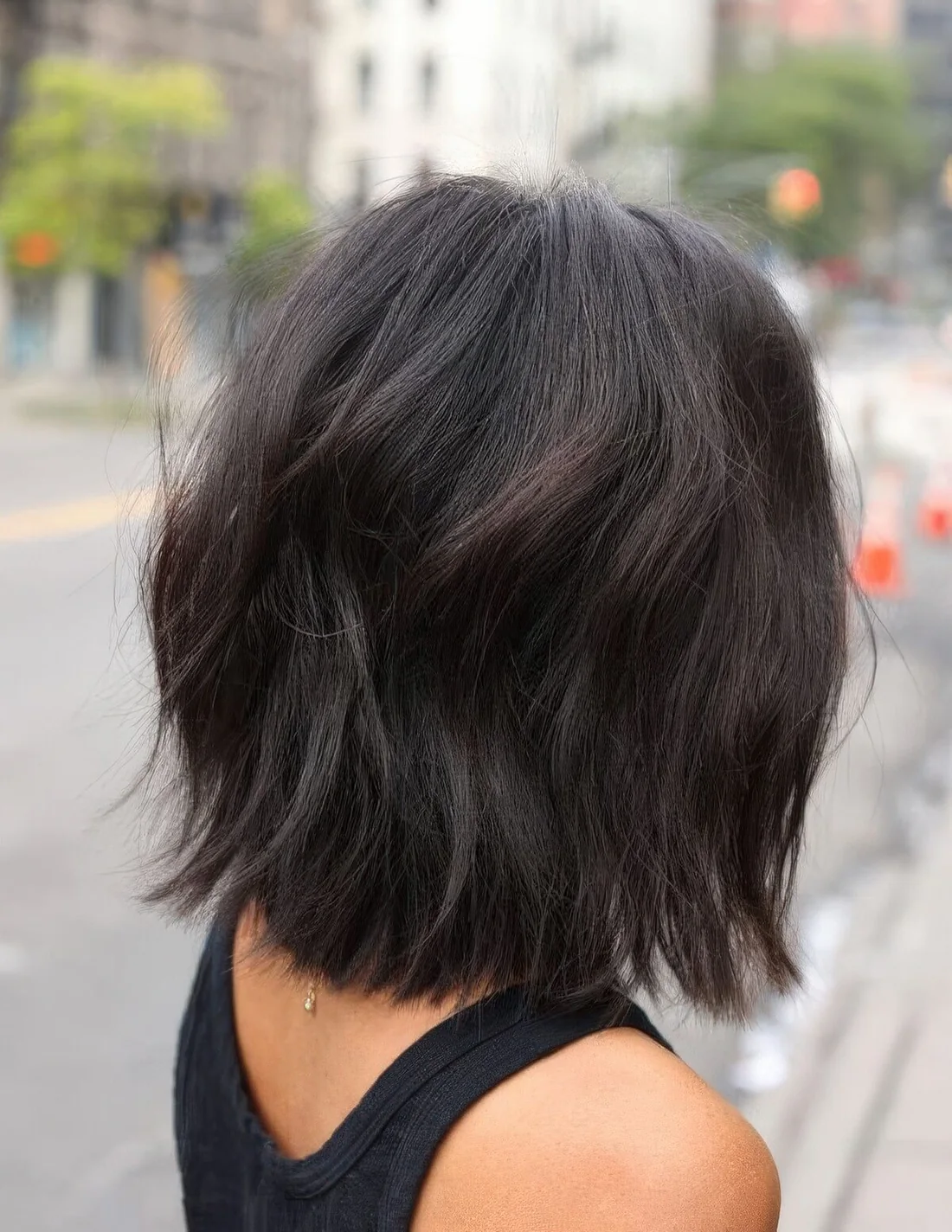Dark brunette long bob with volume, dimension and waves.