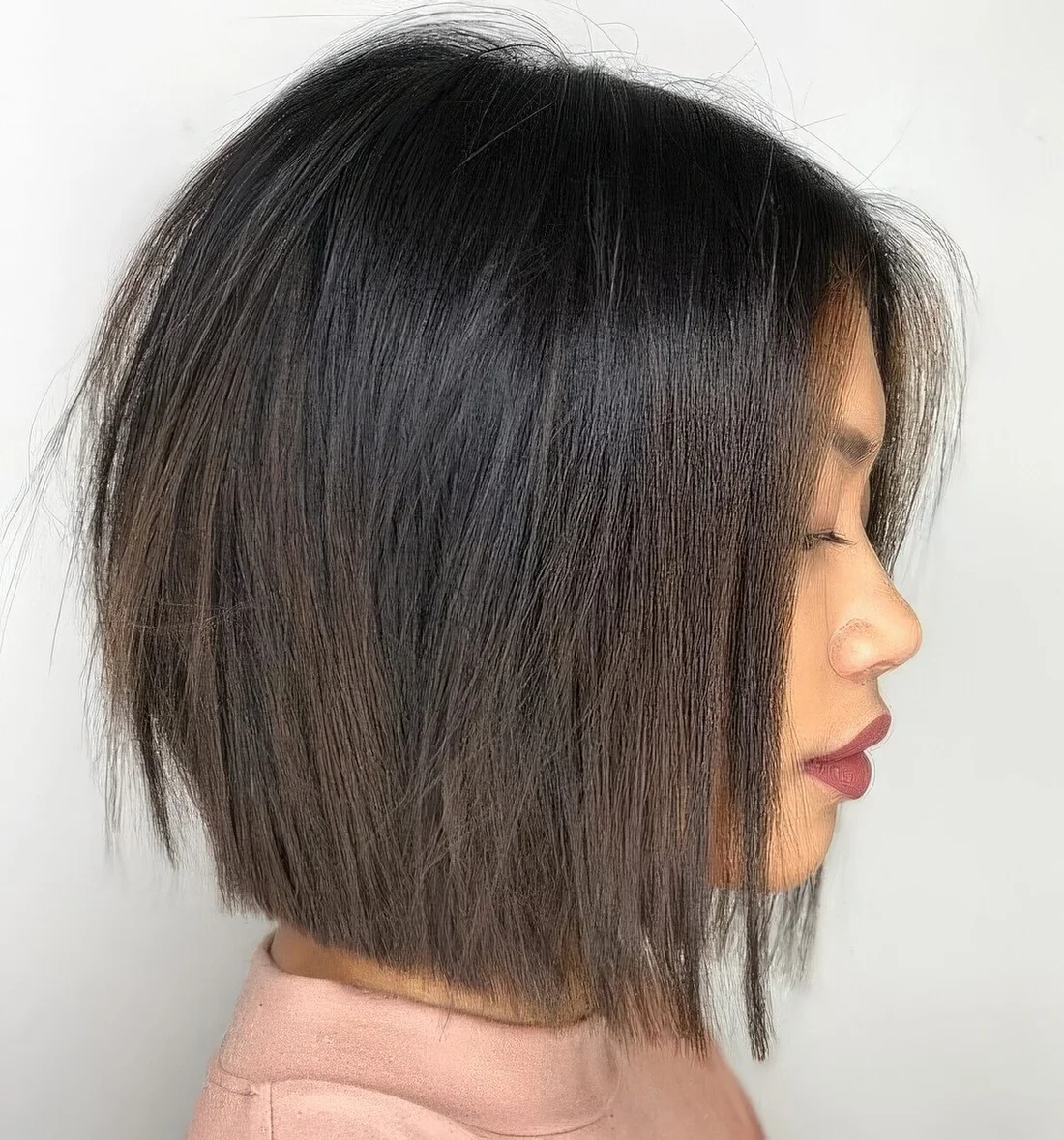 Dark brunette midi bob with volume and texture.