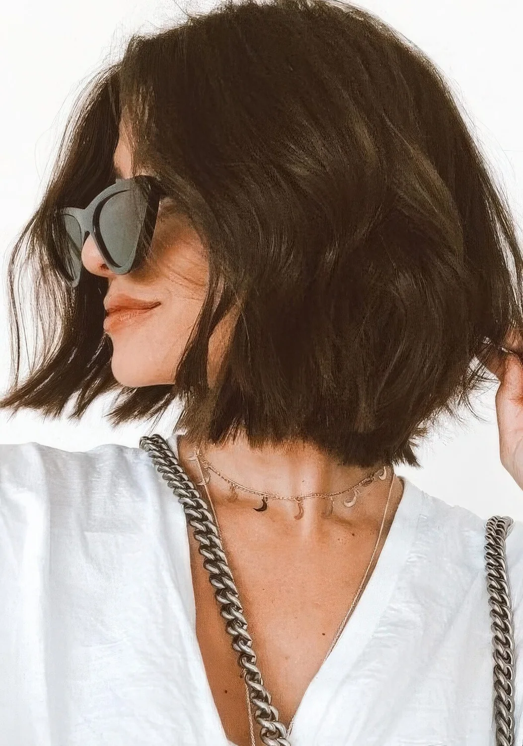 Photo showing dark wavy layered bob, with the hairstyle clearly visible.