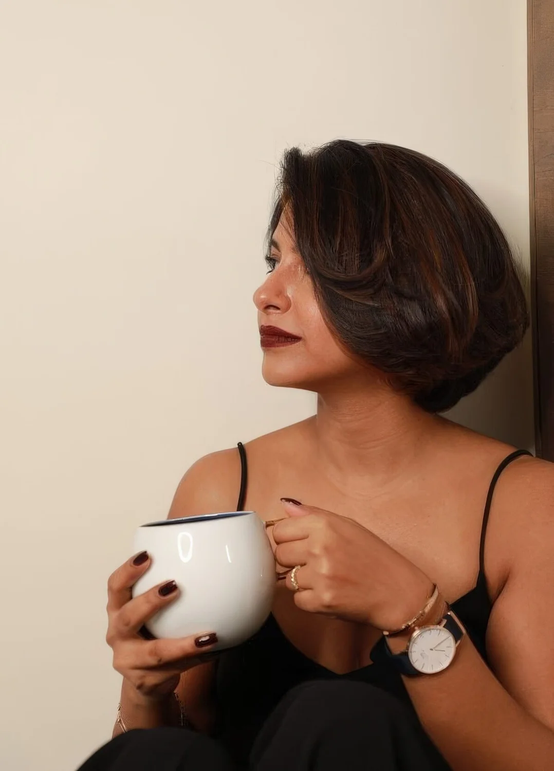 Short brunette bob with burgundy touches and a lot of volume.