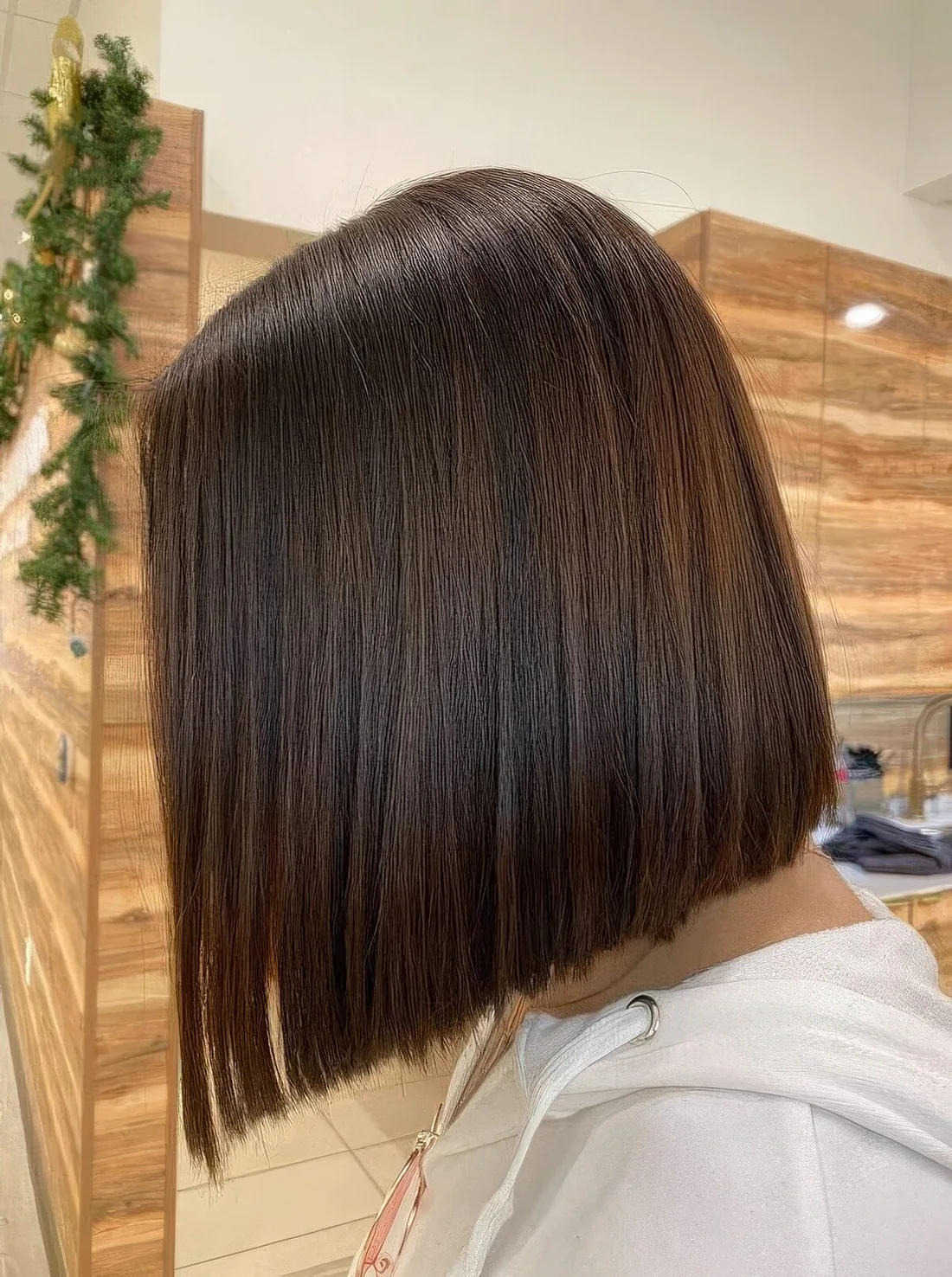 Photo showing straight chocolate brown mid bob, with the hairstyle clearly visible.