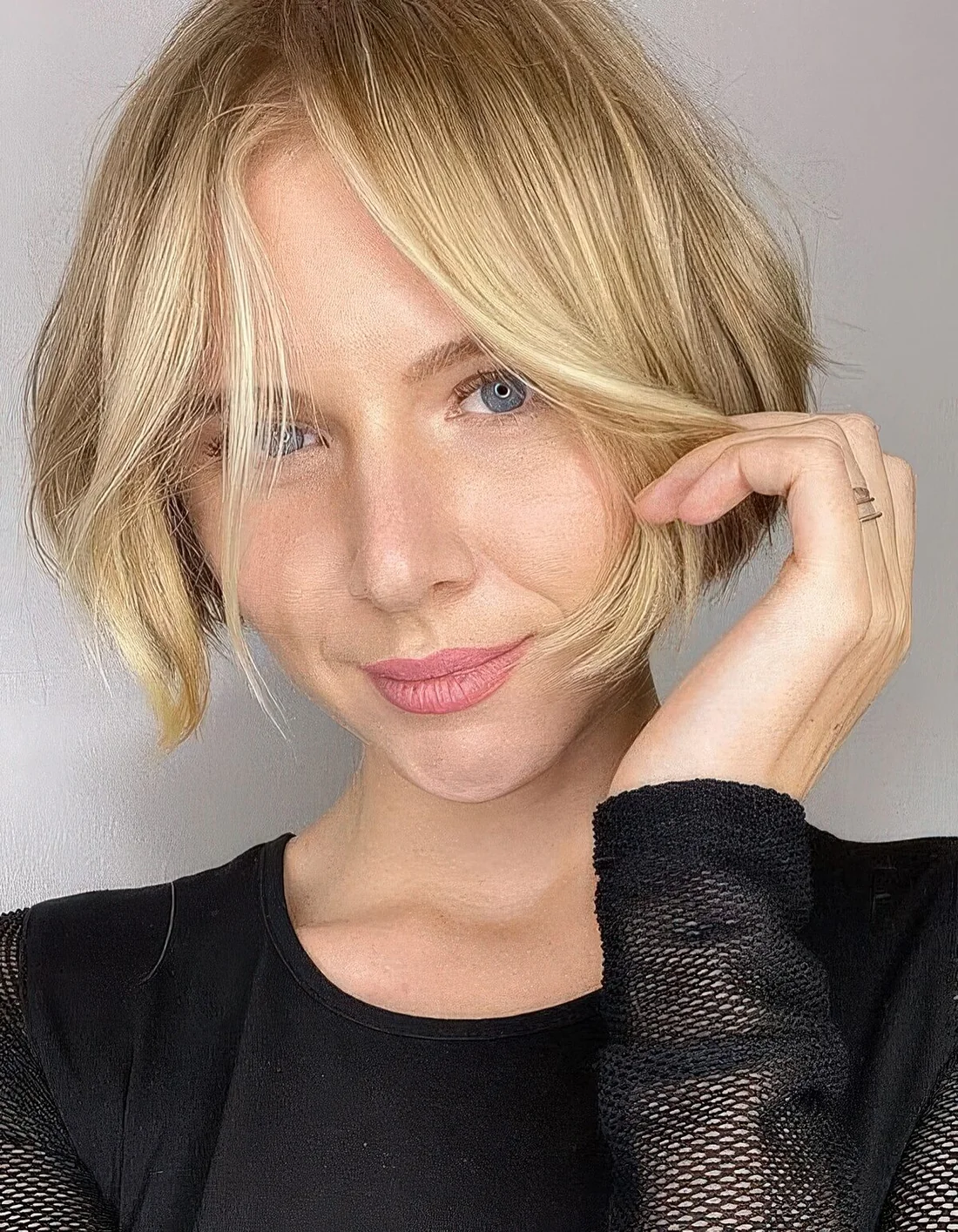 Blonde ear-length bob with messy texture.