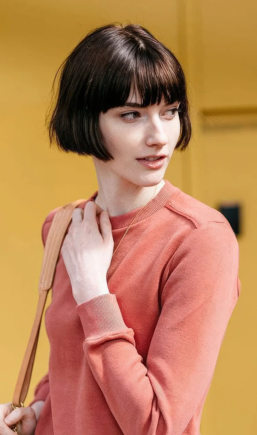 Brown ear-length bob with classic bangs and a bit of texture.