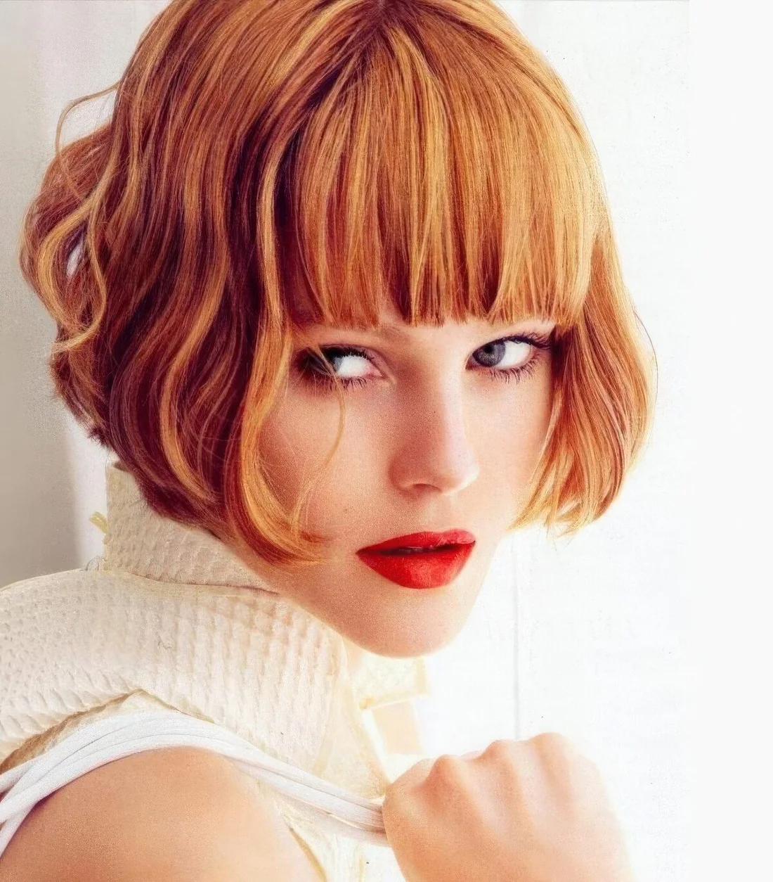 Ginger ear-length bob with a thick classic fringe and waves.