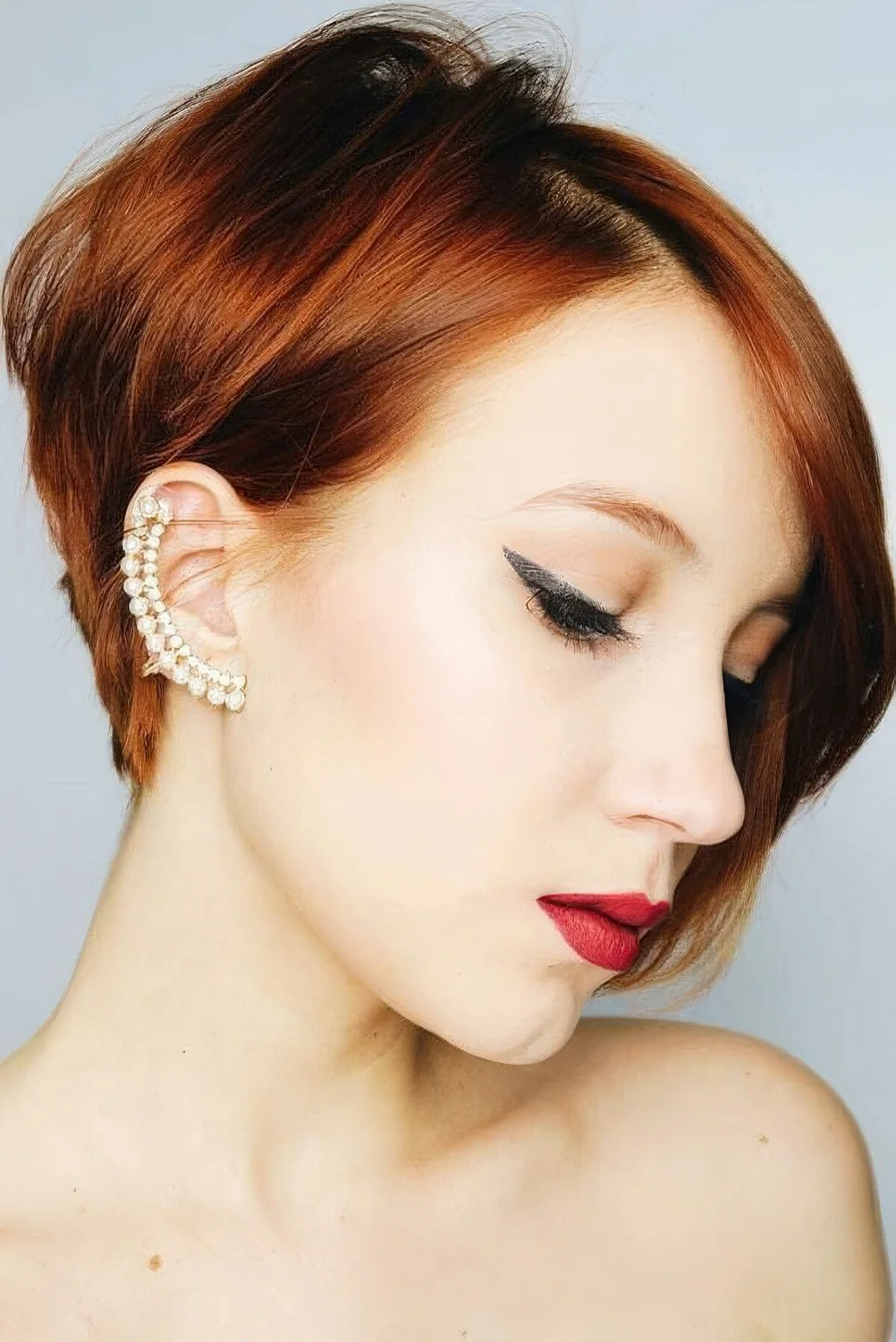 Ginger ear-length bob with side part and volume.