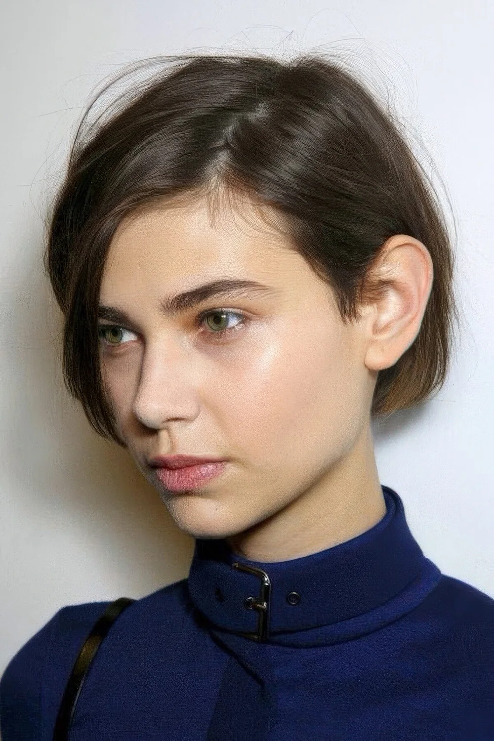 Simple and effortless brunette ea length haircut with a messy part.