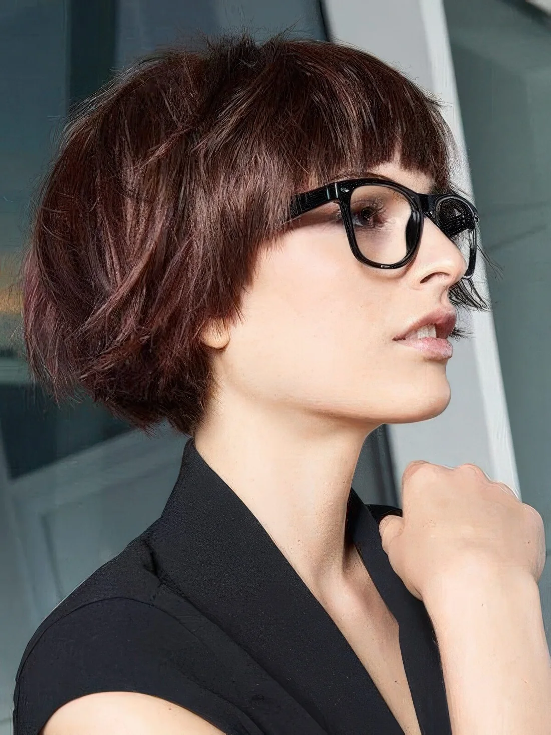 Auburn ear-length bob with a classic fringe and a lot of volume.