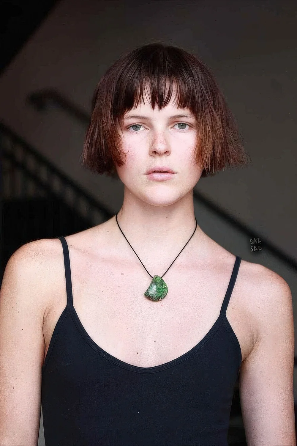 Auburn ear-length bob with wispy bangs.