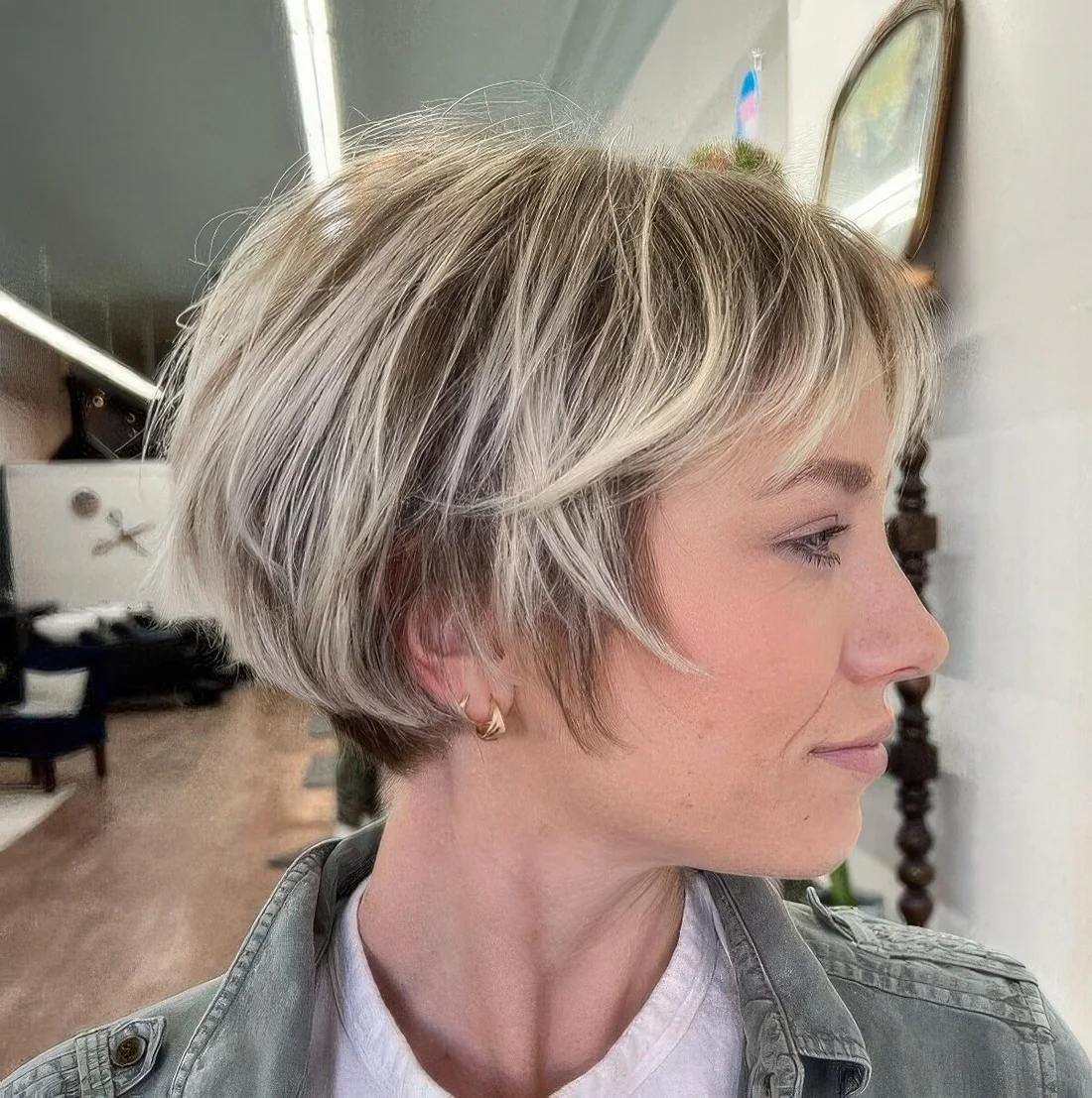 Ear-length bob with blonde balayage and wispy bangs.