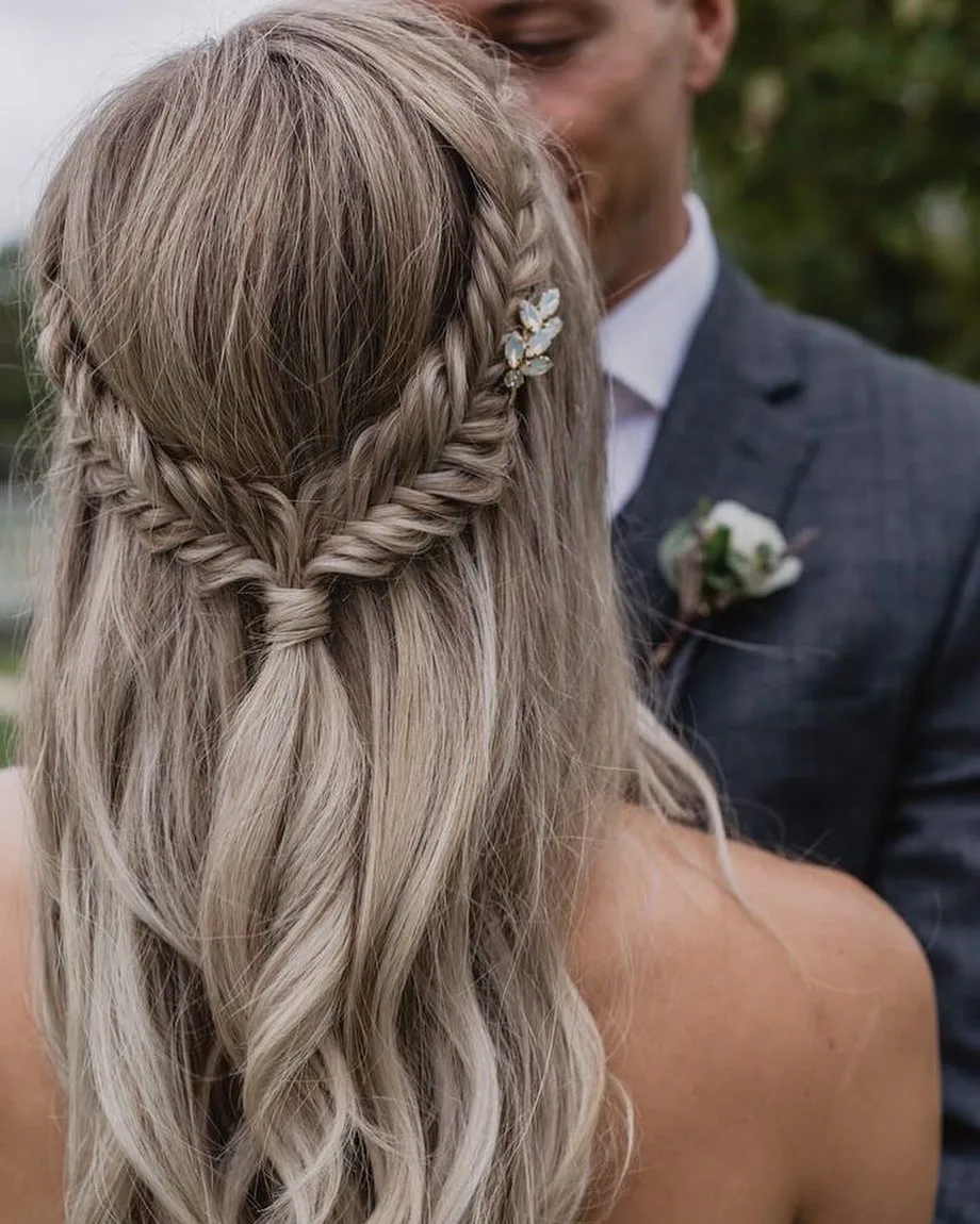 silver blonde waterfall side braid across long loose waves from the back