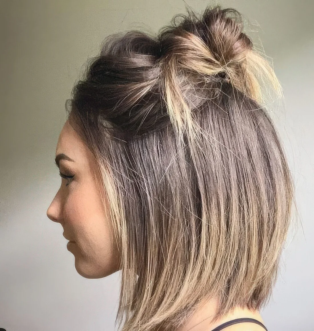 Long bob with a top knot and a messy bump on top.