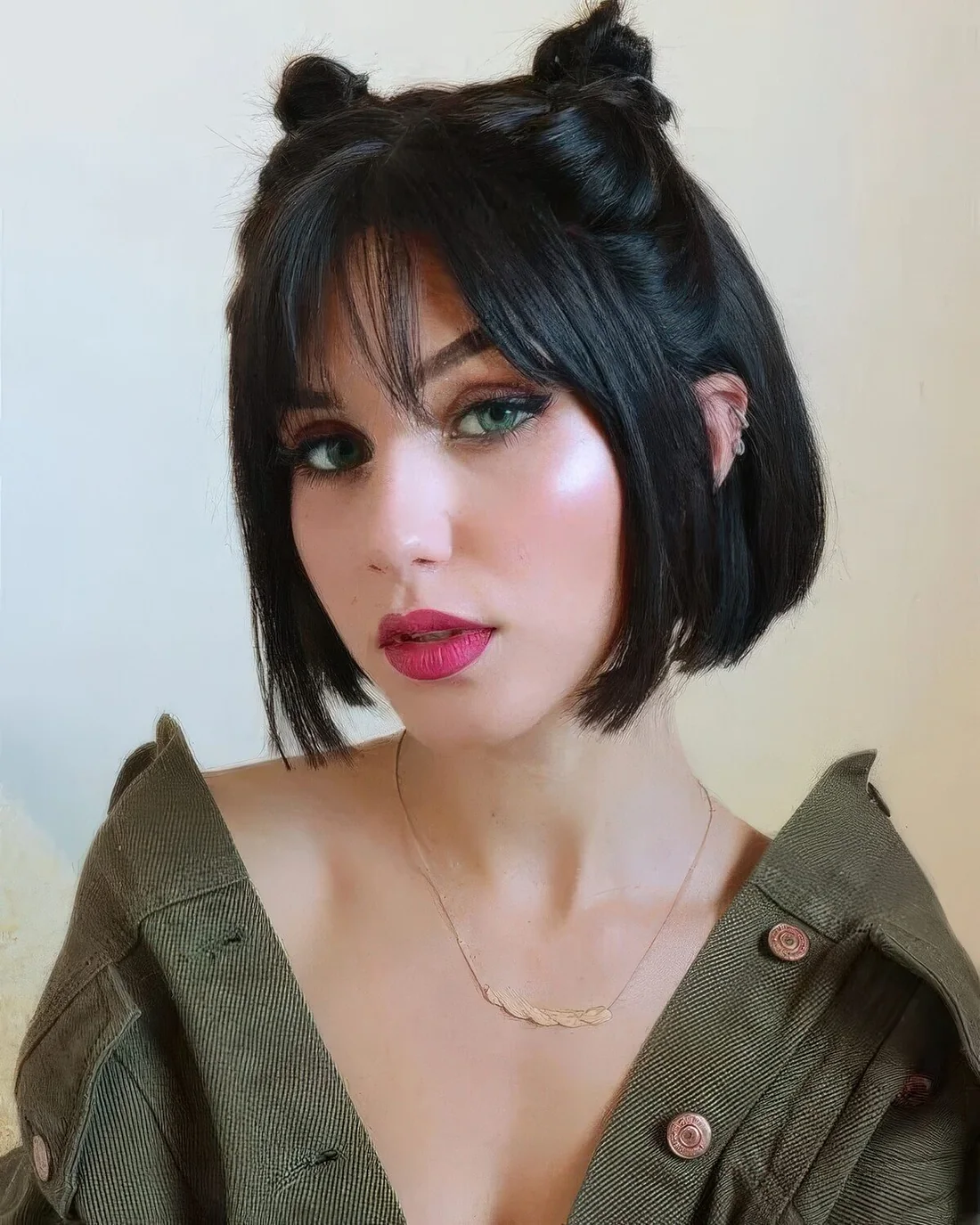 Jaw-length bob with cute top knots and wispy bangs.