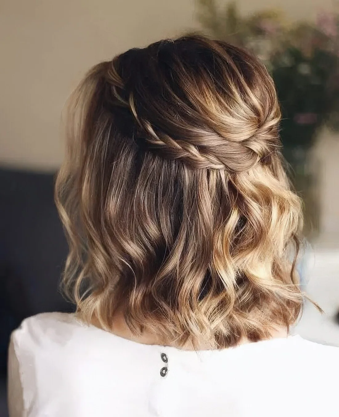 Light brown long bob with golde blonde balayage, waves and a braided halo.