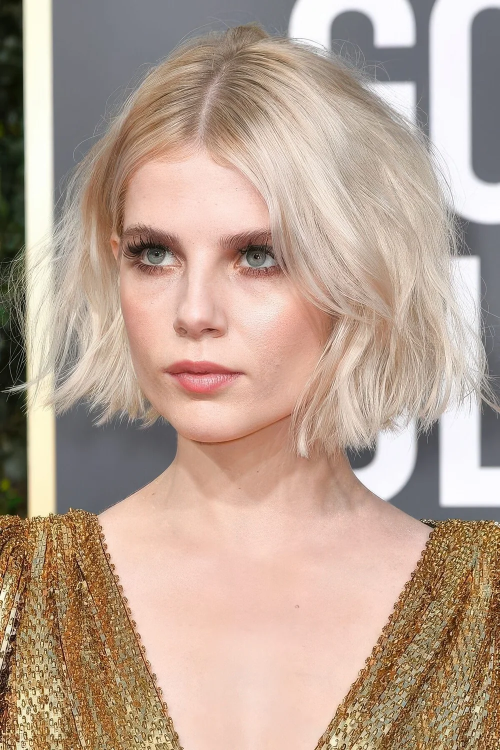 Short blonde bob with much volume and slight waves.