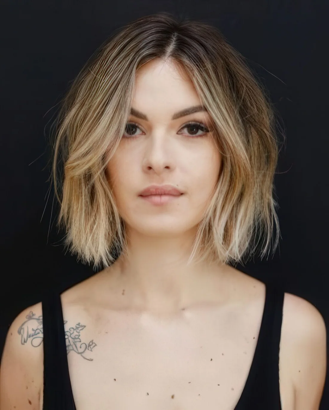 Short bob with volume, texture and blonde balayage and face-framing.