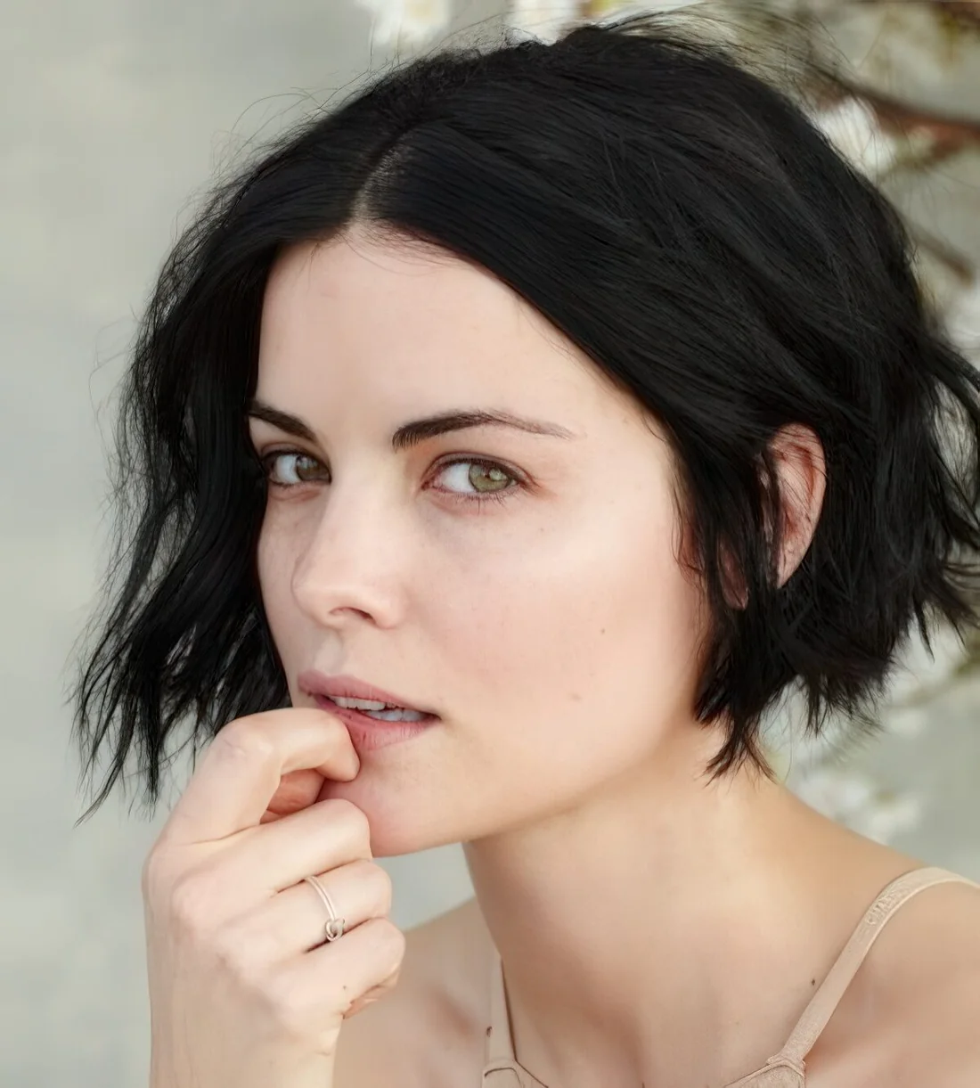 Photo showing short black bob with beachy waves, with the hairstyle clearly visible.