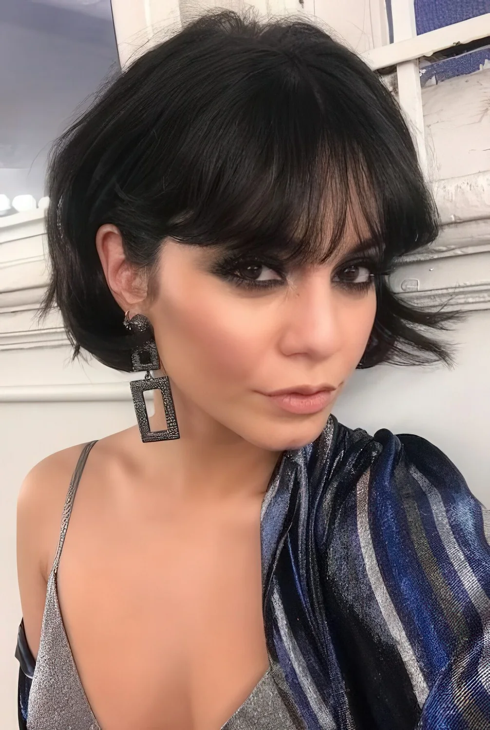 Photo showing short blunt black bob with bangs, with the hairstyle clearly visible.